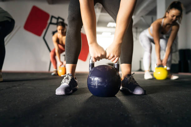 istock Unrecognizable fitness instructor, leading an exercise class in the modern gym 1359858874