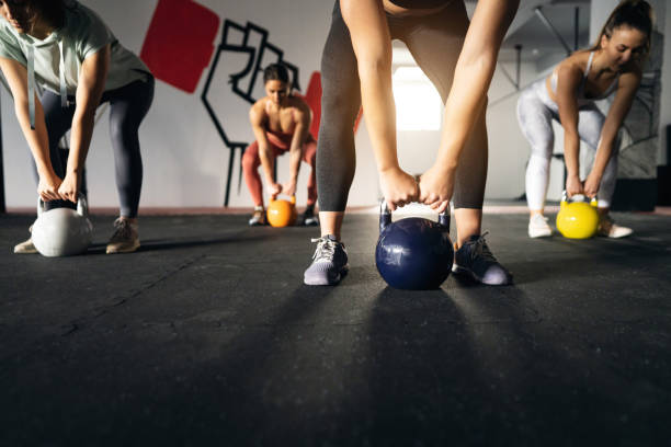 istock Unrecognizable fitness instructor, leading an exercise class in the modern gym 1359858895