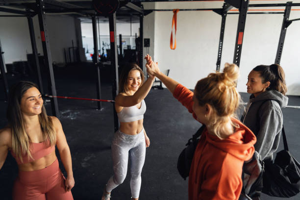 istock Cheerful Caucasian sportswomen, interchange high-five, after they finished the exercise class in the gym 1359859833