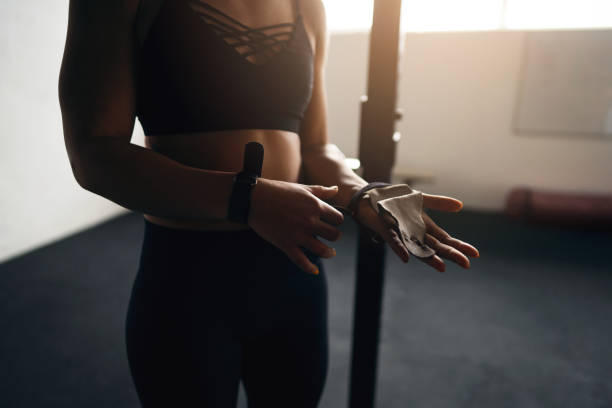 istock Unrecognizable Caucasian spotwoman, adjusting her protective gloves, before she starts with a workout 1359861379