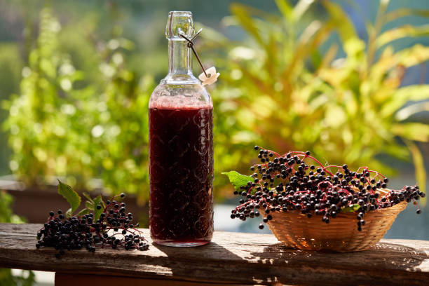 istock A bottle of black elder syrup with fresh elderberries 1359861672