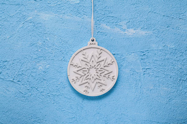 istock Snowflake Stone Plaster, Plaque Plaster or Concrete. Enhanced durability to frost when hardened. Concrete, Gypsum Christmas ball on blue textured gypsum. Building Material Used in Construction. 1359861678