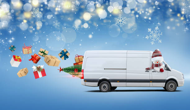 istock Delivery van driven by a cute snowman carries Christmas presents 1359861840