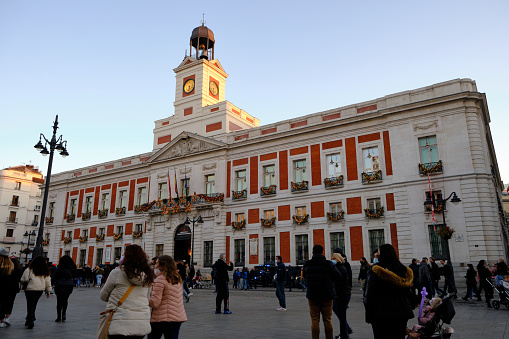 Madrid, Spain - DEC 17 2021: Royal House of the Post Office (Real Casa de Correos) in Puerta del Sol square. A 18th century building built for the postal service, but currently serves as the office of the President of the Community of Madrid, the head of the regional government of the Autonomous Community of Madrid.