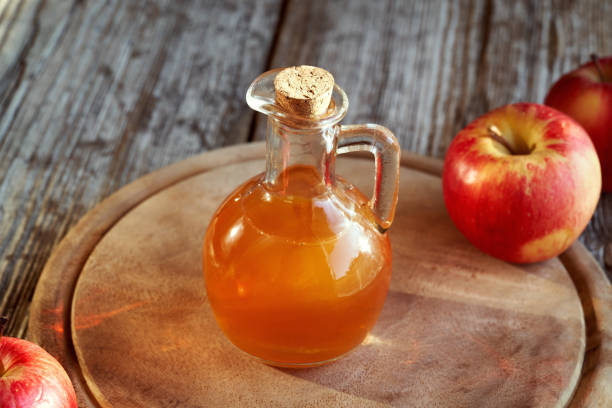 istock A bottle of apple cider vinegar with fresh red apples 1359862723