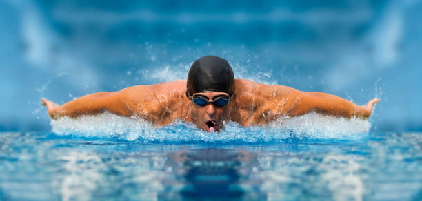 istock Man in swimming pool. Butterfly style 1359865357