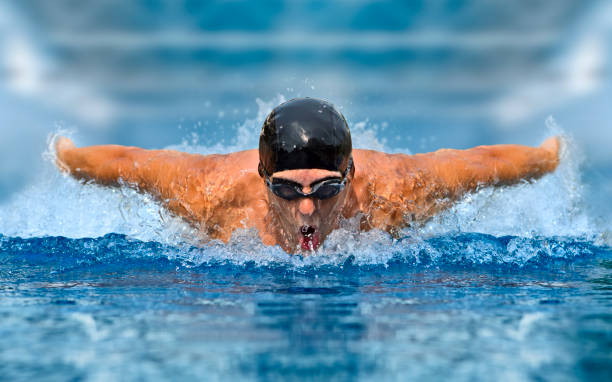 istock Man in swimming pool. Butterfly style 1359865360