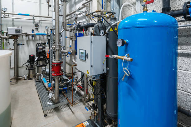 istock Water filter warehouse with four large blue tanks 1359866292
