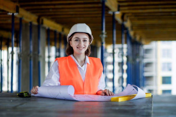 istock Architect or engineer working, browsing building project indoor of construction site with blueprint plan. Woman construction engineers or architects working people 1359868458