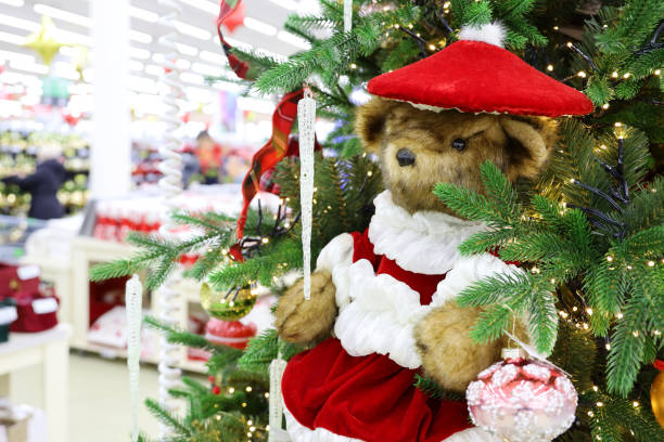 istock Christmas tree with toy bear in a shopping mall 1359869691