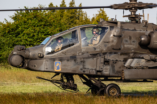 Kaposujlak, Hungary - June 5, 2021: US Army Boeing AH-64 Apache military helicopter at air base. Aviation and rotorcraft. Transport and airlift. Fly and flying.