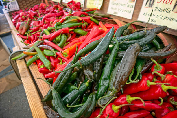 Close-up of juicy ripe red sweet peppers on market. Eco-friendly and farm products. Fresh vegetables and healthy food concept