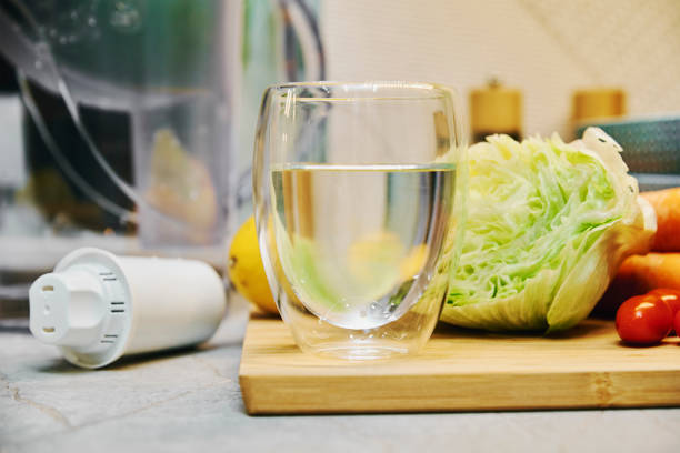 istock Glass of clean water and vegetables 1359872332