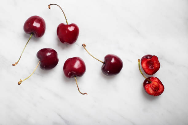 istock flat lay of cherries and one cherry in half 1359873119