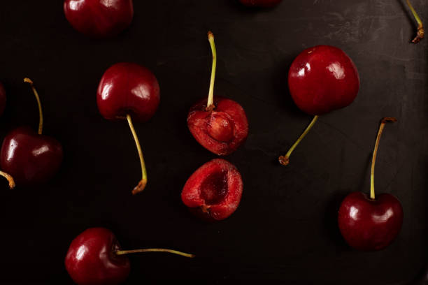 istock cherries and a half cherry with seed on a dark background 1359873126