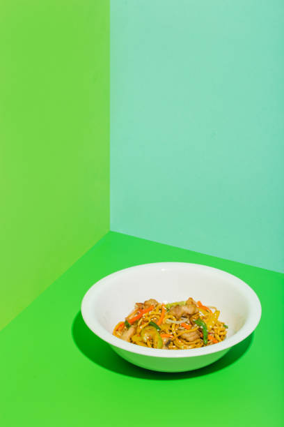 istock Noodles with chicken on green background 1359873293