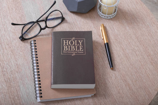 istock Bible and glasses on the table in the home interior. Bible study concept 1359874739