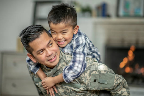 istock Little Boy Piggy Backing His Military Father 1359876369
