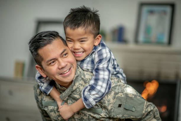 Little Boy Piggy Backing His Military Father
