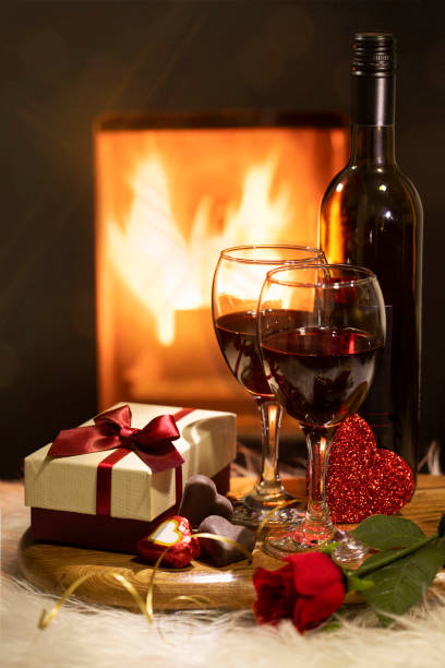 istock Red Wine and a Gift with Chocolates and rose 1359877826