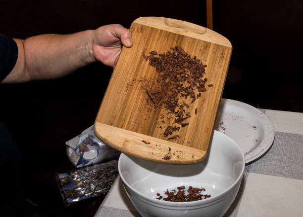 istock A woman's hand pours pieces of cinnamon sticks into a container for making a tea mixture. Pieces of cinnamon sticks on a wooden board. 1359878649