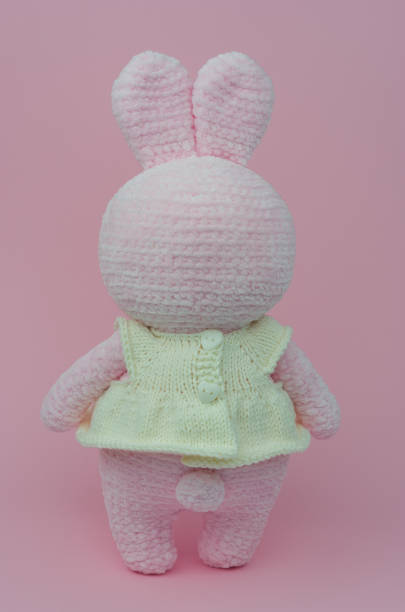 istock Crochet plush pink rabbit. Soft toy knitted bunny. 1359879064