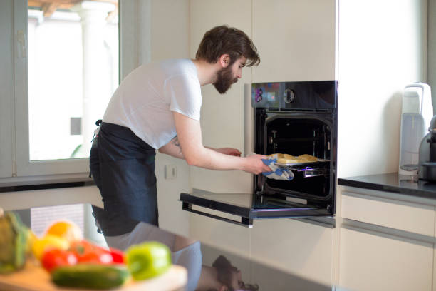 istock Young bearded man baking pastries in the kitchen at home 1359880768