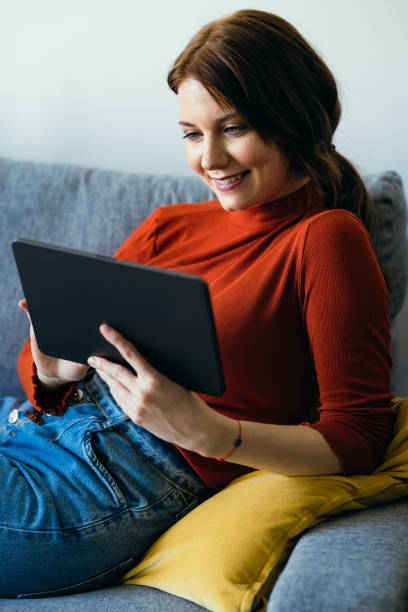 istock Home Office: Smiling Young Woman Using a Digital Tablet 1359884271