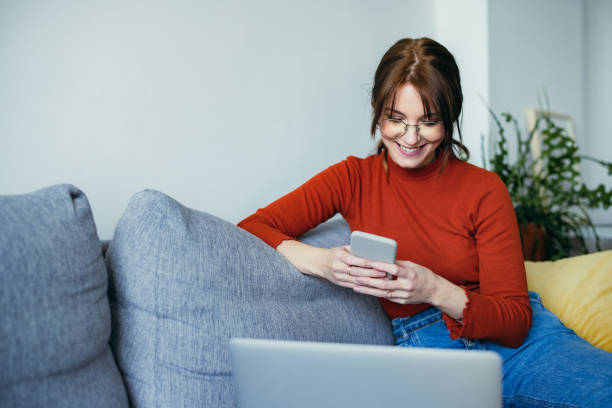 istock Home Office: Young Woman Typing on a Phone 1359884329