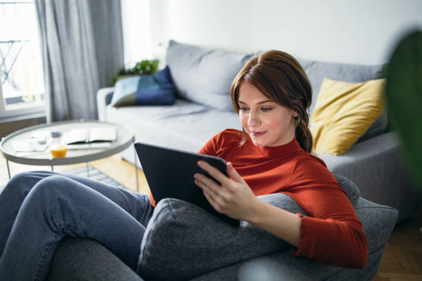 istock Student Life: Young Woman Using a Digital Tablet at Home 1359885008