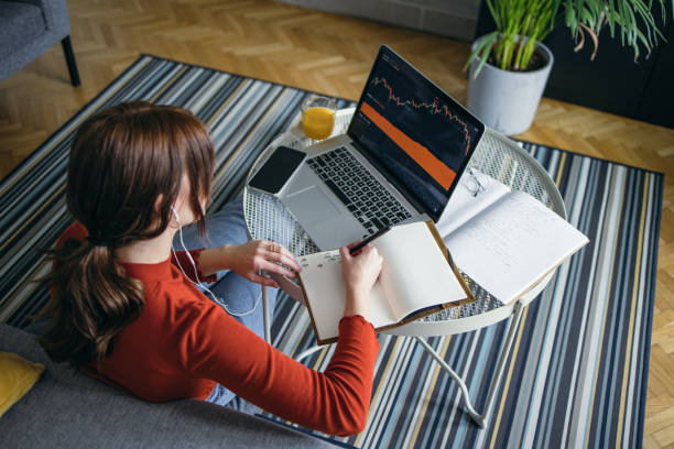 istock Unrecognizable Business Woman Analyzing Graph on Laptop at Home (Copy Space) 1359885061