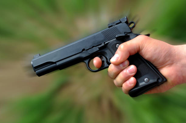 istock Gun in hand close up photo 1359887000