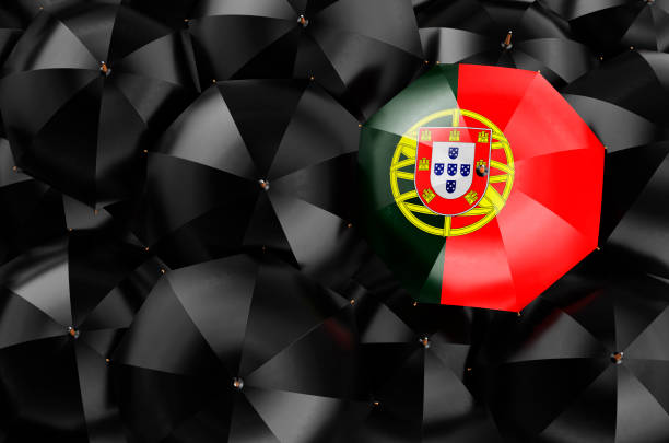istock Umbrella with Portuguese flag among black umbrellas, 3D rendering 1359890410
