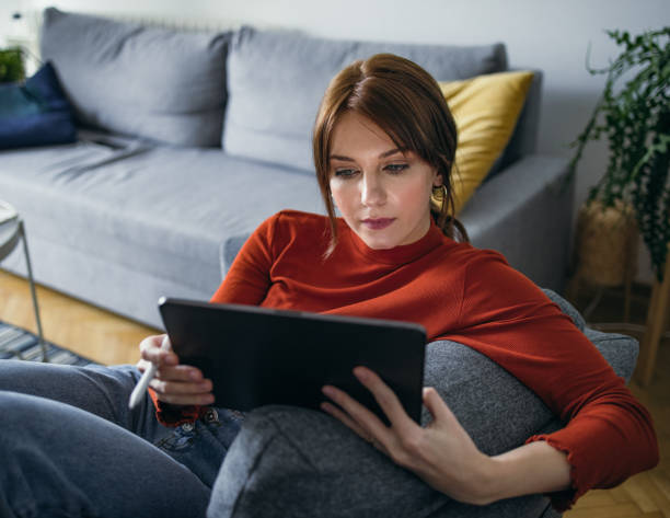 istock Student Life: Young Woman Using a Digital Tablet at Home 1359891073