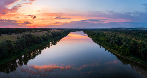 istock Aerial panoramic landscape with sunset over the river and beautiful clouds on the sky. 1359891809
