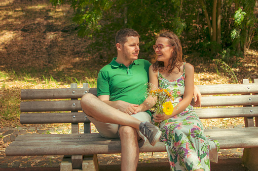 couple sitting on the park bench.