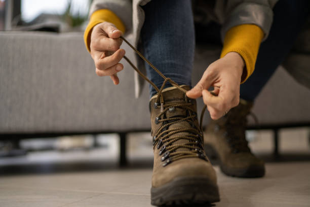 istock Close up of woman's boots while tying shoelace 1359892738