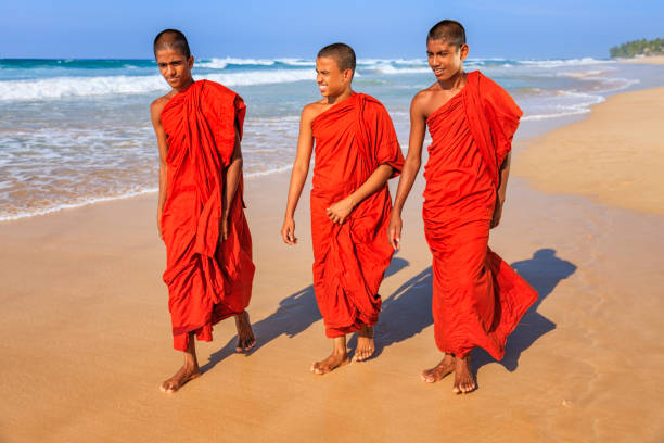 istock Sri Lankan young buddhist monks walking on the beach, Ceylon 1359894492