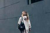 An Unrecognizable Woman Walking On The Street, Going To Her Training