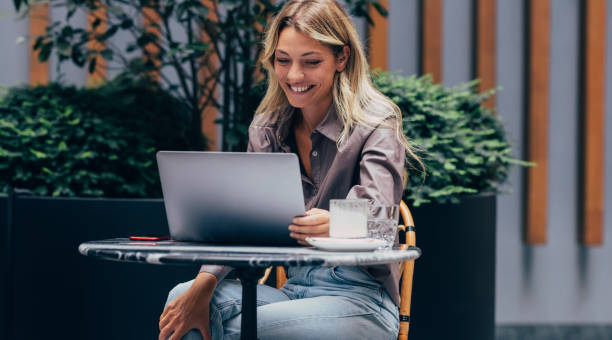 istock A Beautiful Woman Sitting In A Cafe And Having An Online Language Class 1359896026