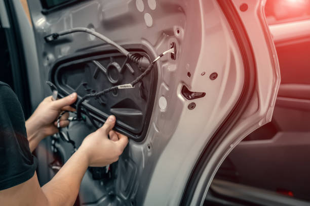 Auto service worker disassembles car door for repair close up Auto service worker disassembles car door for repair close up. car audio equipment stock pictures, royalty-free photos & images