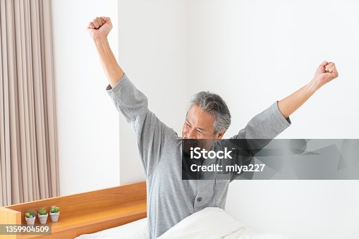 istock elderly man in night clothes in bed,Smile 1359904509