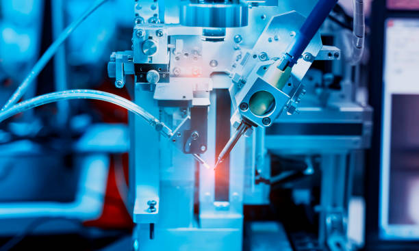 istock automatic robot for print circuit board (PCB) assembly machine during soldering or welding part 1359907355
