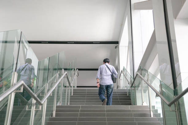 istock Man walking up the stairs inside a subway building. 1359908343