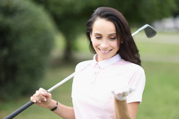 istock Smiling professional golf player woman hold ball on palm 1359908528