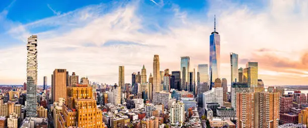 Aerial panorama of Lower Manhattan skyline at sunset viewed from above Greenwich street in Tribeca neighborhood.