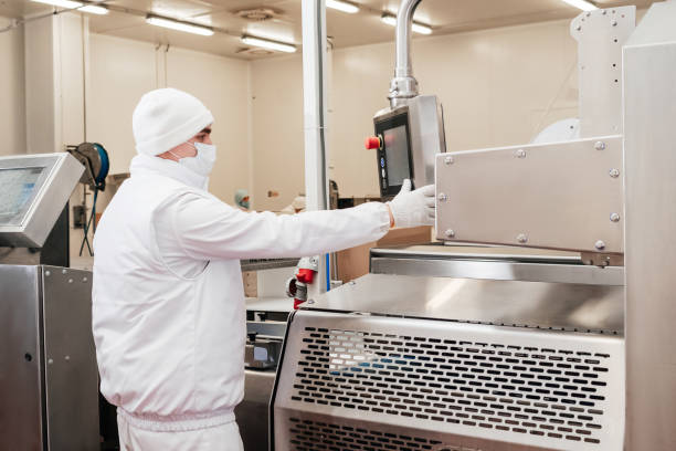 istock Meat processing plant.Industrial equipment at a meat factory.Modern poultry processing plant.People working at a chicken factory - stock photo.Automated production line in modern food factory. 1359909914