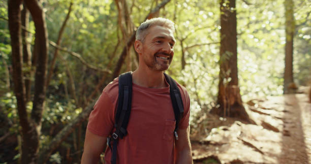 istock Shot of a handsome man exploring the forest on his own 1359913724