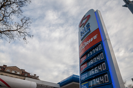 Picture of the NIS sign with their logo on their gas station for Serbia in Belgrade. Naftna Industrija Srbije is a Serbian multinational oil and gas company with headquarters in NIS building, Novi Sad, Serbia. NIS is one of the most profitable companies in Serbia and one of the largest domestic exporters. It employs around 11,000 people in Serbia and the region.