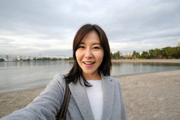 istock Businesswoman taking selfie on the beach 1359917619